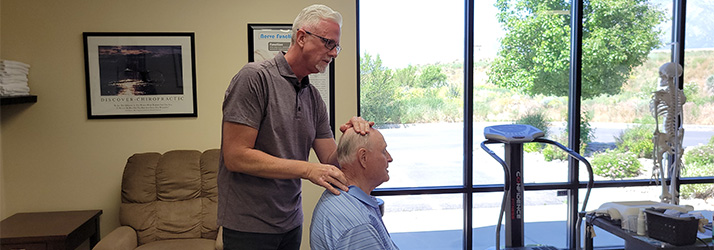Chiropractor Ogden UT Peter Raether With Patient Chiropractor Ogden UT Peter Raether With Patient